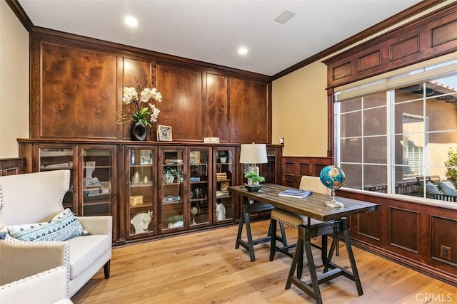 home office featuring light wood-style flooring, recessed lighting, ornamental molding, wainscoting, and a decorative wall