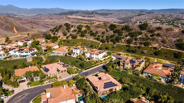 drone / aerial view featuring a residential view and a mountain view