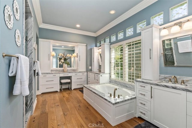 bathroom with hardwood / wood-style floors, two vanities, and ornamental molding