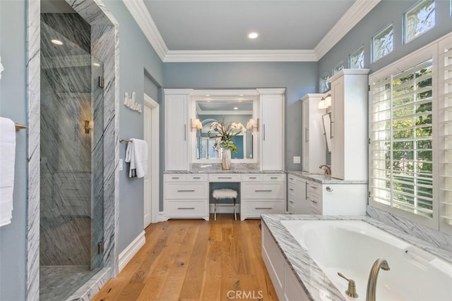 bathroom featuring vanity, crown molding, a bath, and a marble finish shower