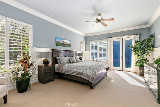 bedroom featuring a wainscoted wall, a ceiling fan, access to outside, carpet floors, and crown molding