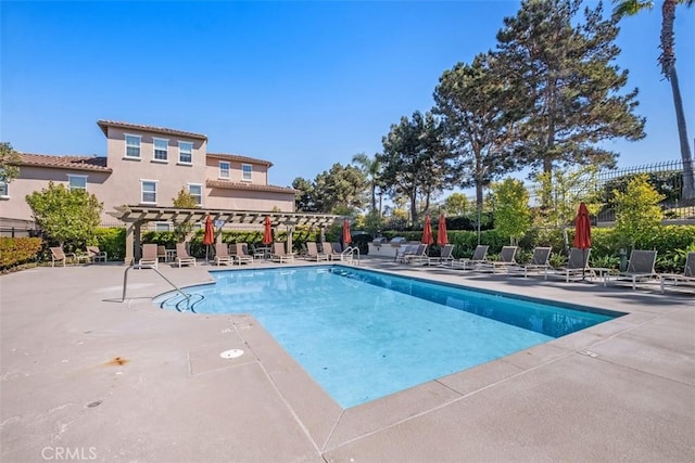 pool featuring a patio, fence, and a pergola