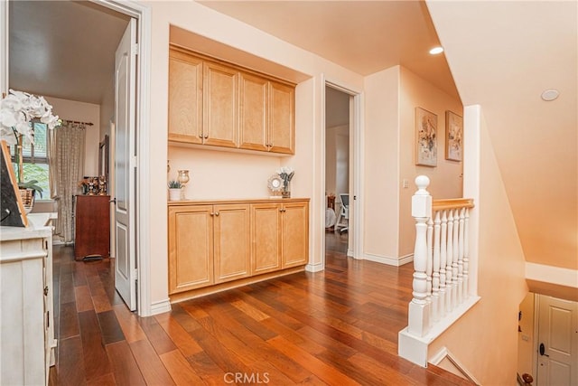 interior space featuring dark wood finished floors, recessed lighting, an upstairs landing, and baseboards