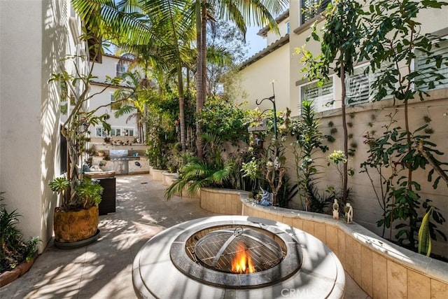 view of patio / terrace with a grill and a fire pit