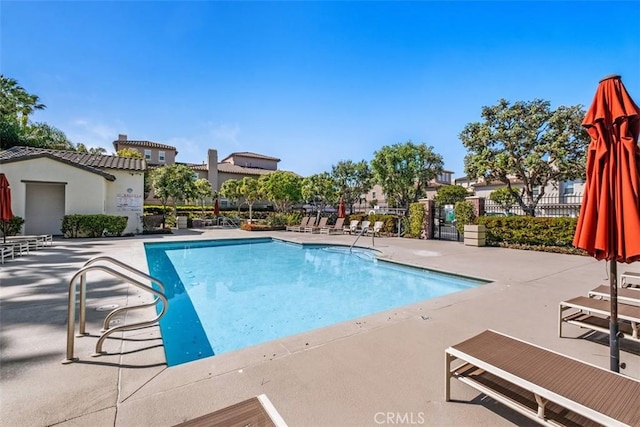 community pool featuring a patio and fence