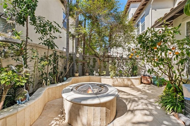 view of patio featuring a fenced backyard and an outdoor fire pit