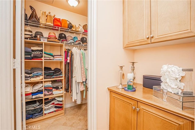 spacious closet with light tile patterned floors