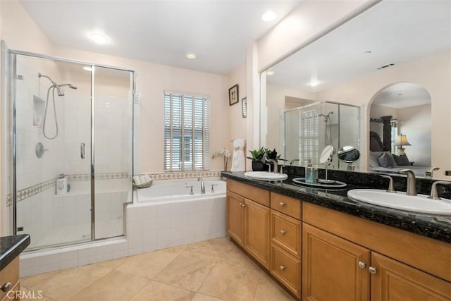 full bathroom featuring visible vents, a stall shower, a garden tub, and a sink