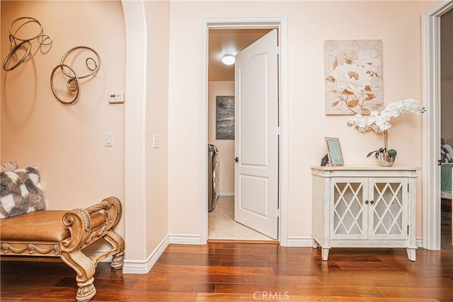 hall featuring baseboards and wood finished floors