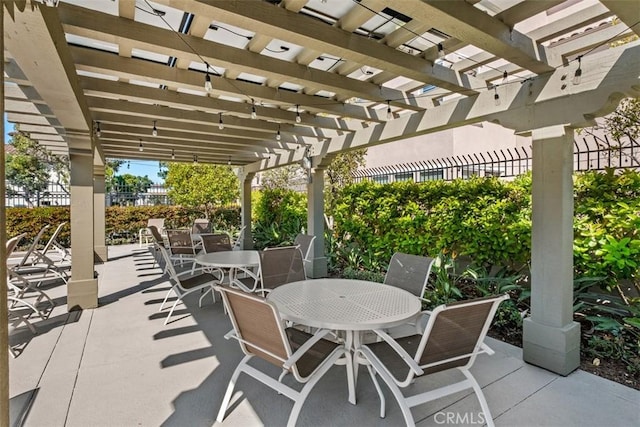 view of patio featuring outdoor dining space and a pergola