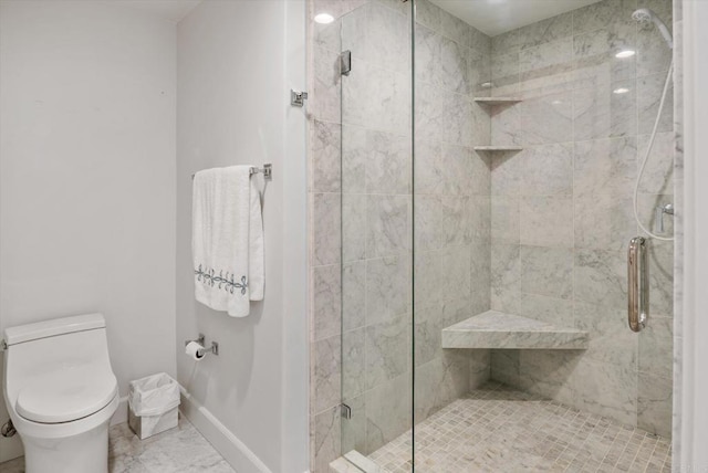 full bath featuring baseboards, toilet, marble finish floor, and a shower stall