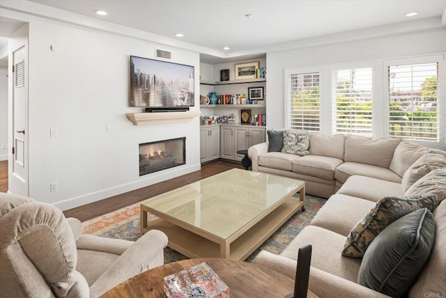 living room featuring visible vents, plenty of natural light, dark wood-style floors, and recessed lighting