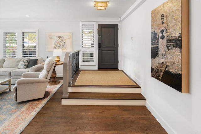 interior space featuring baseboards and wood finished floors