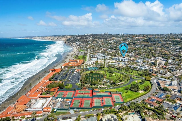 drone / aerial view with a water view and a beach view