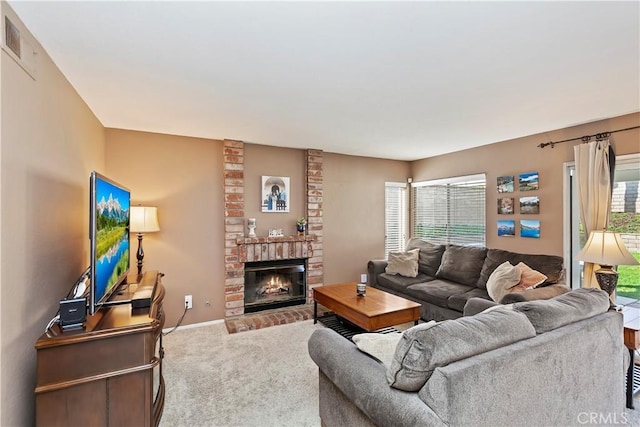 carpeted living area featuring visible vents, baseboards, and a brick fireplace