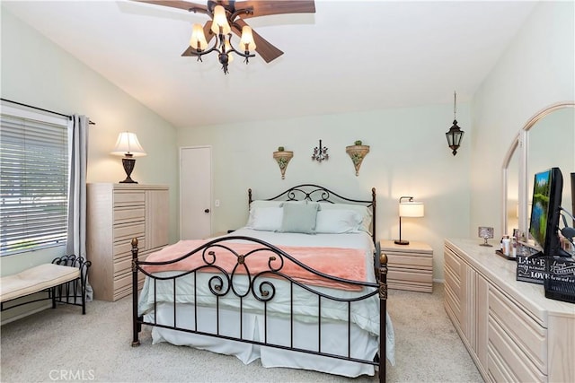 bedroom featuring light colored carpet, a ceiling fan, and lofted ceiling