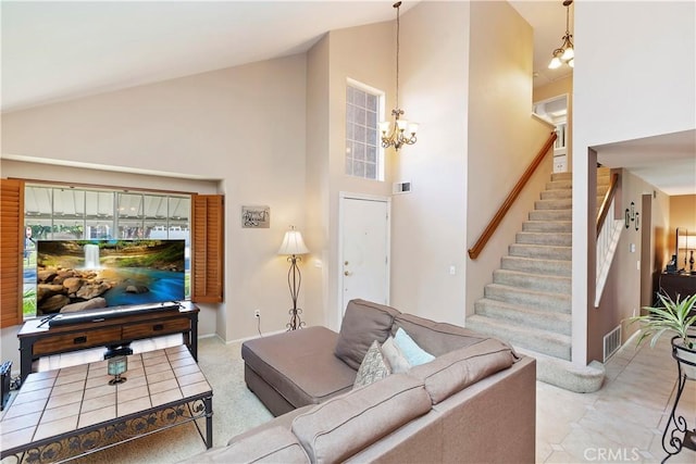 living area featuring baseboards, visible vents, high vaulted ceiling, stairs, and a chandelier