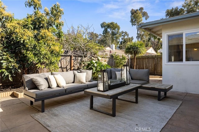 view of patio / terrace featuring an outdoor living space, a fenced backyard, and a wooden deck