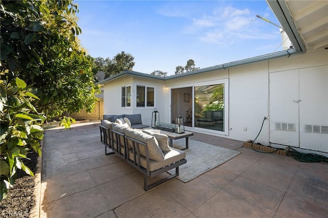 view of patio featuring fence and an outdoor hangout area