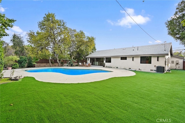 view of pool featuring a patio, fence, a yard, cooling unit, and a fenced in pool