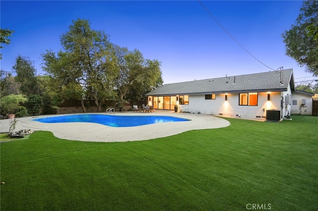 view of swimming pool with a yard, a patio, a fenced in pool, and central AC unit