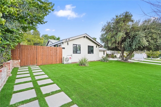 view of yard with ac unit and fence