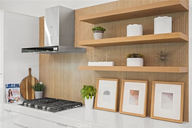 kitchen featuring stainless steel gas cooktop, ventilation hood, and open shelves