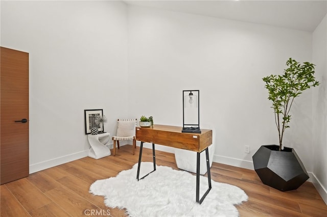 home office featuring baseboards and wood finished floors