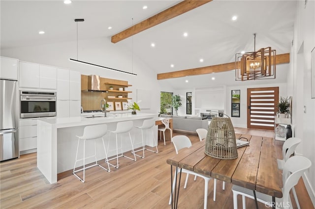 dining room featuring high vaulted ceiling, an inviting chandelier, light wood-style flooring, recessed lighting, and beamed ceiling