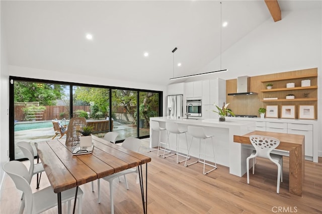 dining area with beam ceiling, recessed lighting, light wood finished floors, and high vaulted ceiling