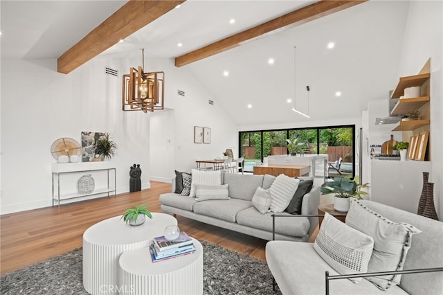 living room featuring wood finished floors, baseboards, high vaulted ceiling, beam ceiling, and a notable chandelier