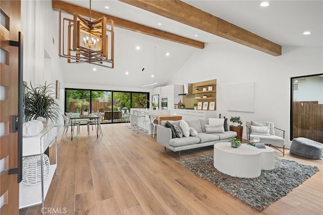 living area with high vaulted ceiling, recessed lighting, light wood-style floors, beamed ceiling, and a chandelier