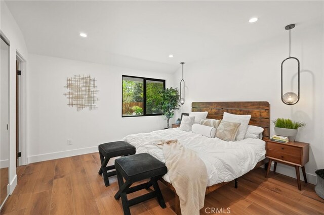 bedroom with recessed lighting, baseboards, and wood finished floors