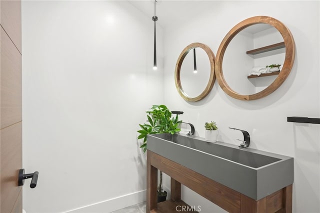 bathroom with baseboards and a sink