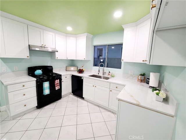 kitchen with black appliances, light stone countertops, under cabinet range hood, white cabinetry, and a sink