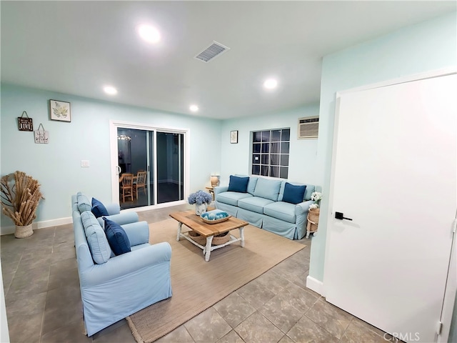 living room with recessed lighting, visible vents, baseboards, and an AC wall unit