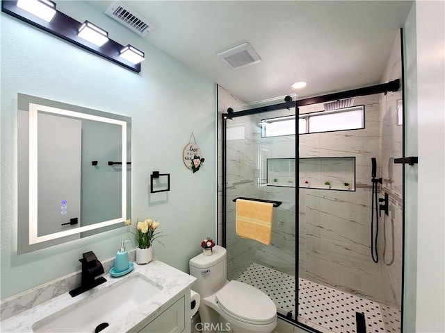 bathroom featuring a marble finish shower, visible vents, toilet, and vanity