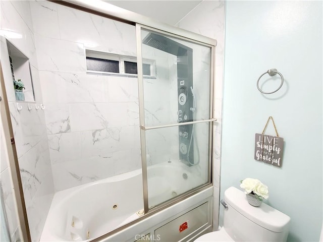 bathroom featuring toilet and a combined bath / shower with jetted tub