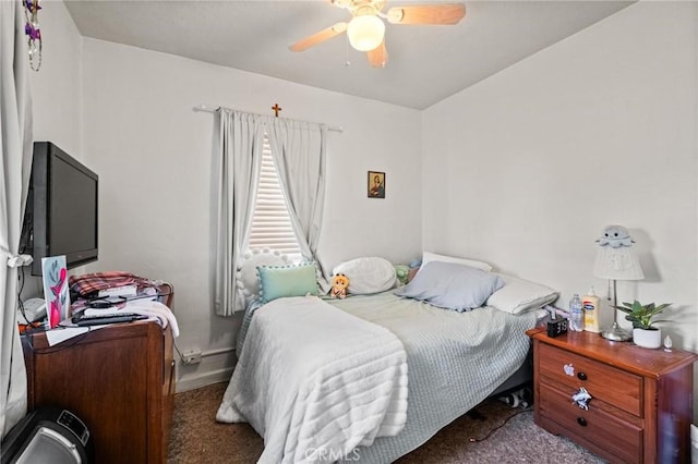 carpeted bedroom featuring baseboards and ceiling fan