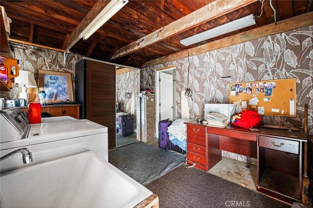 laundry area featuring laundry area, washing machine and dryer, wallpapered walls, and a sink