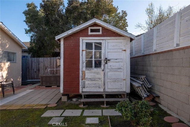 view of shed featuring a fenced backyard