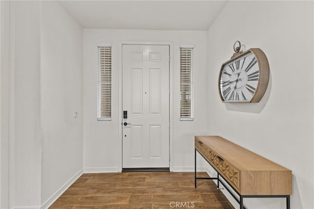 entrance foyer featuring wood finished floors and baseboards