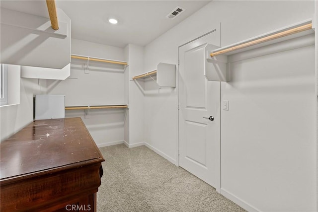 walk in closet with visible vents and carpet floors