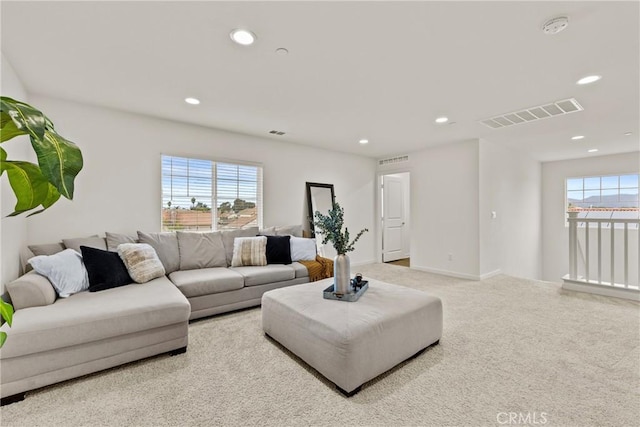 living area with recessed lighting, visible vents, and plenty of natural light