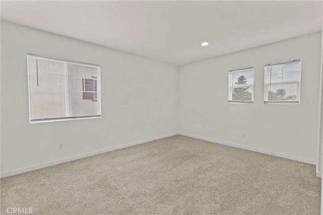 carpeted spare room featuring recessed lighting and baseboards