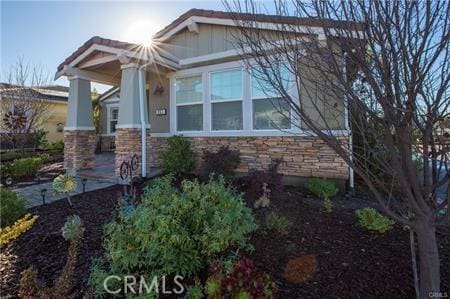 view of side of property featuring stone siding