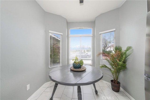 dining room featuring baseboards and marble finish floor