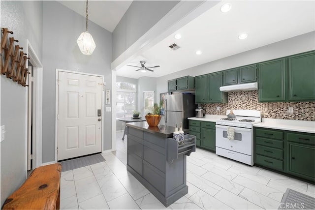 kitchen with white range with gas cooktop, marble finish floor, under cabinet range hood, freestanding refrigerator, and green cabinetry