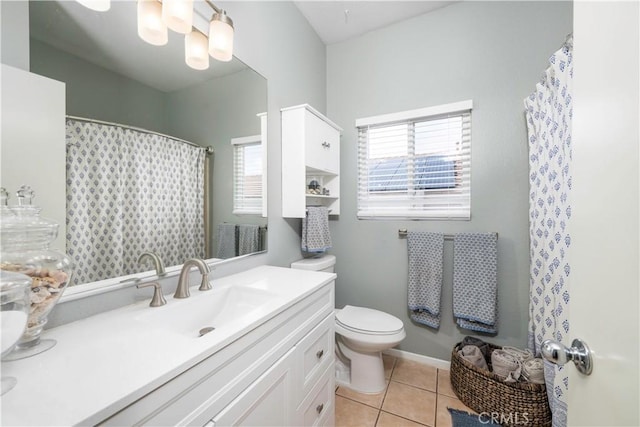 bathroom featuring toilet, vanity, and tile patterned flooring