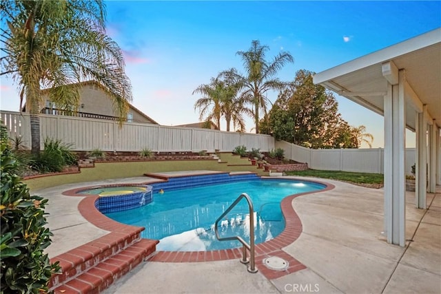 view of pool featuring a pool with connected hot tub, a fenced backyard, and a patio area